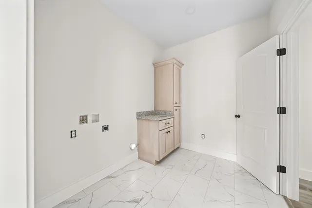 a view of a kitchen with white cabinets