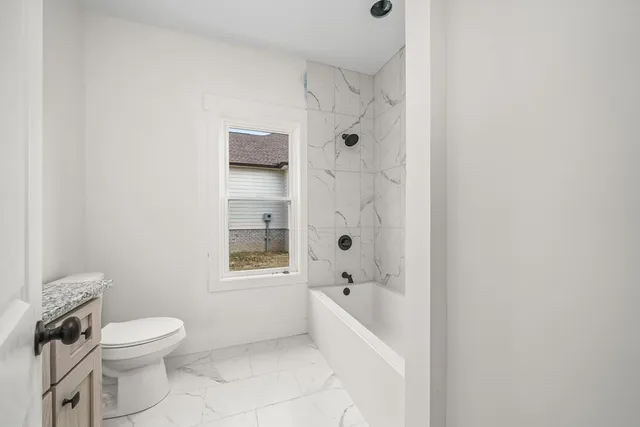 a bathroom with a toilet and a bathtub