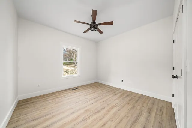 wooden floor in an empty room with a window