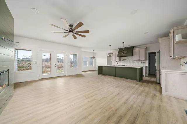 a large white kitchen with a cabinetry and kitchen view