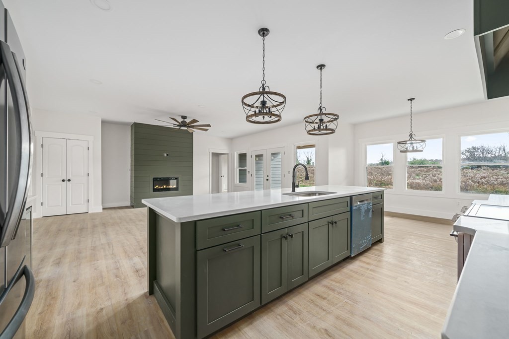 6584 Thomas Twin Oaks Road Baxter, TN 38544 - Photo 10 of 23 a kitchen with stainless steel appliances granite countertop cabinets a sink a window and chairs