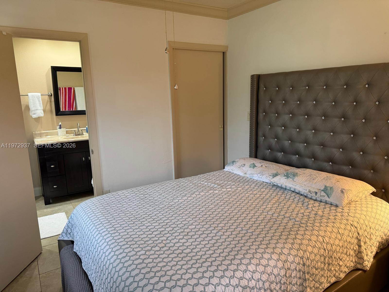 1350 Northwest 96th Street, Unit 2 Miami, FL 33147 - Photo 2 of 12 a bedroom with a bed and a dresser