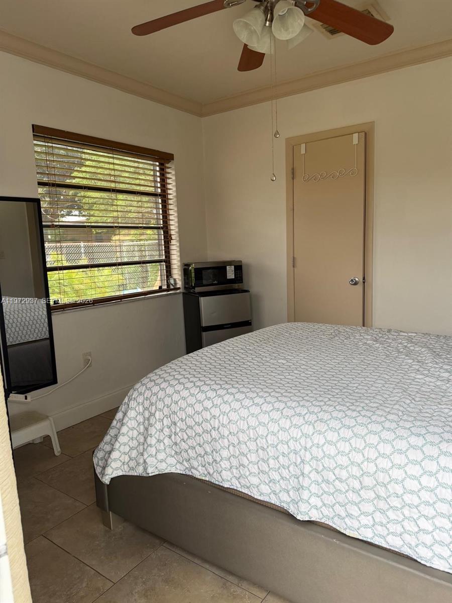1350 Northwest 96th Street, Unit 2 Miami, FL 33147 - Photo 7 of 12 a bedroom with a bed and window