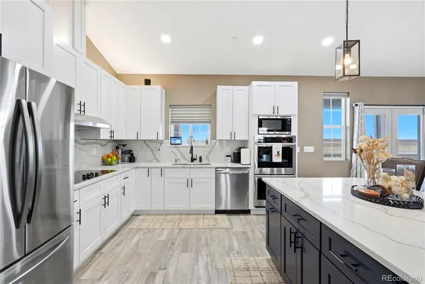 a kitchen with stainless steel appliances a refrigerator sink and microwave