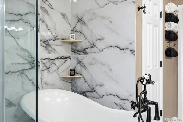 a bathroom with a bathtub and shower