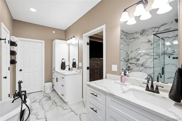 a bathroom with a double vanity sink mirror and shower