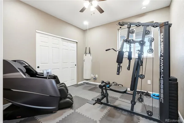 a room with gym equipment and windows