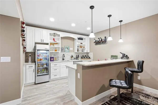 a kitchen with kitchen island a stove a center island and a wooden floor
