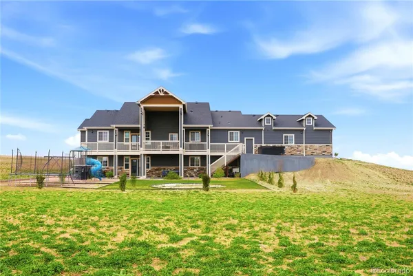 a view of a house with backyard and ocean view