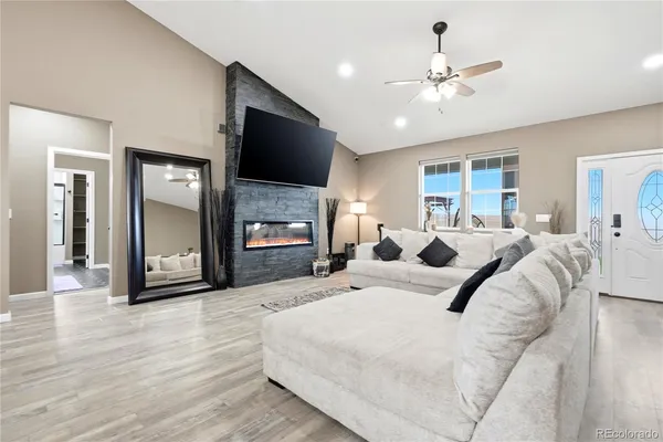 a large bedroom with a large bed and flat tv
