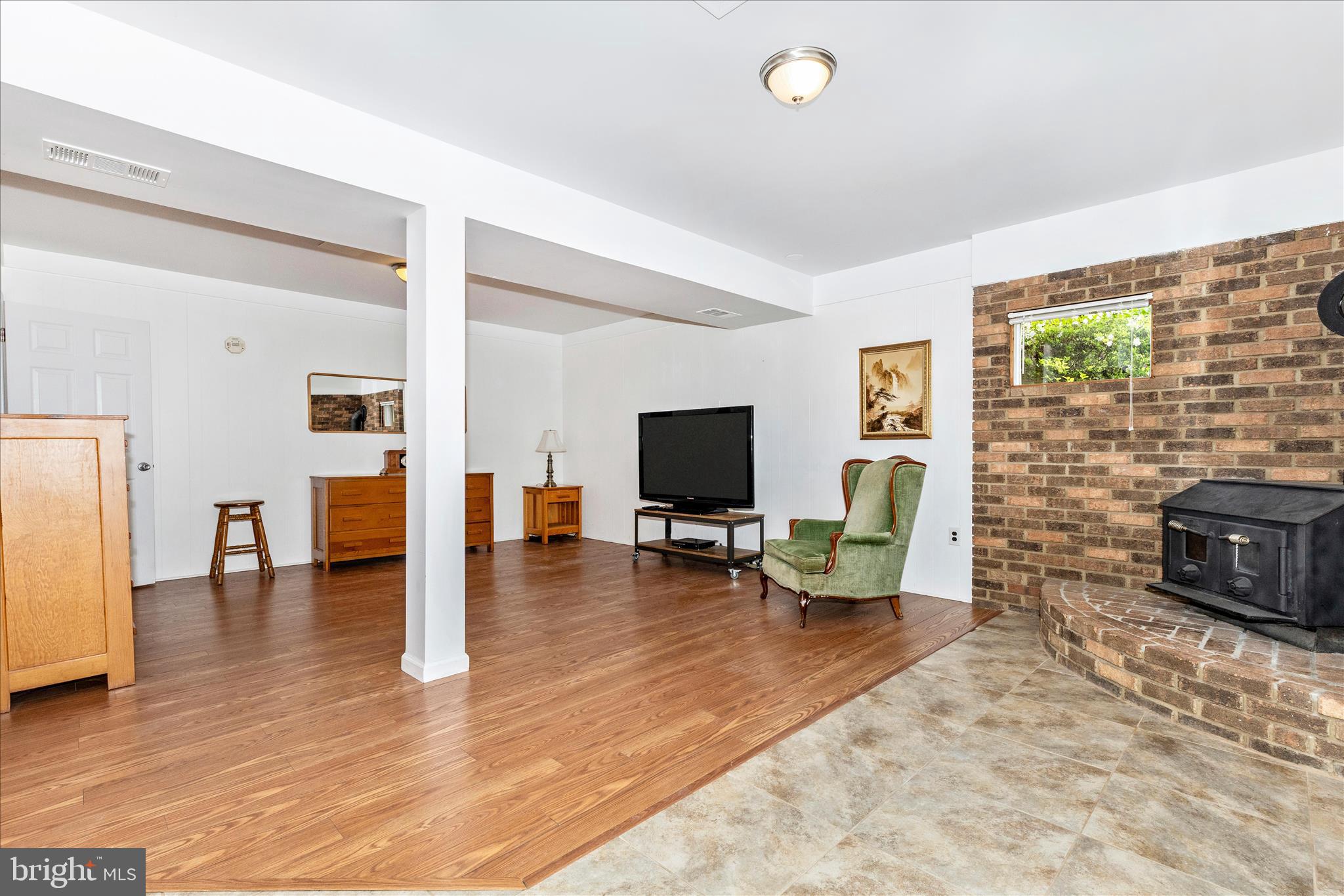 7946 Helmart Drive Laurel, MD 20723 - Photo 38 of 50 Lower level rec area w woodburning stove
