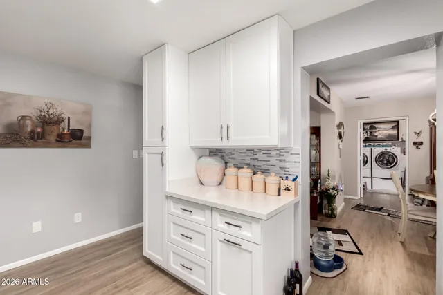 a kitchen with refrigerator a microwave a sink and cabinets