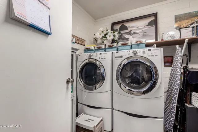 a view of a hallway with entryway a dining table and chairs