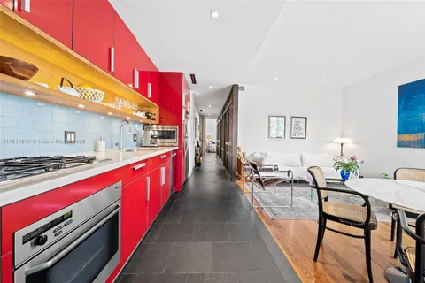 a kitchen with stainless steel appliances granite countertop a stove a sink and a refrigerator