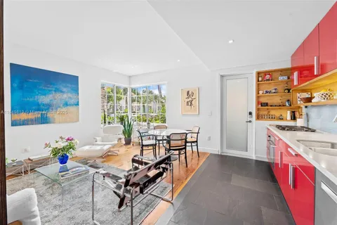 a living room with furniture stove and large window