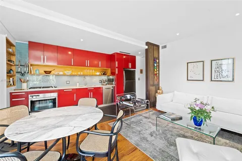 a kitchen with a dining table chairs and window