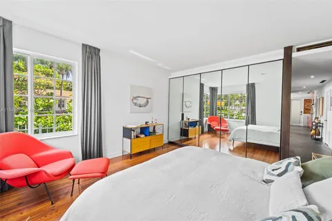 a bed room with a bed and a chair