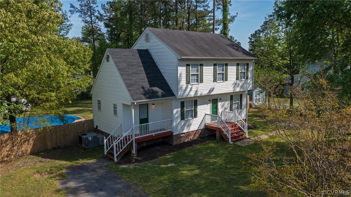 4025 Frye Terrace Colonial Heights, VA 23834 - Photo 11 of 30 a front view of a house with a garden and trees