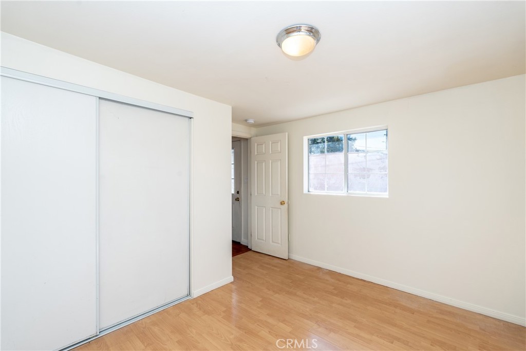 16302 Rochlen Street Hacienda Heights, CA 91745 - Photo 11 of 17 a view of an empty room with wooden floor and a window
