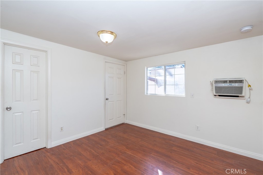16302 Rochlen Street Hacienda Heights, CA 91745 - Photo 15 of 17 a view of an empty room with wooden floor and a window