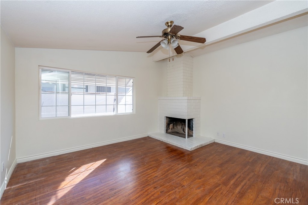 16302 Rochlen Street Hacienda Heights, CA 91745 - Photo 5 of 17 a view of empty room with wooden floor and fireplace