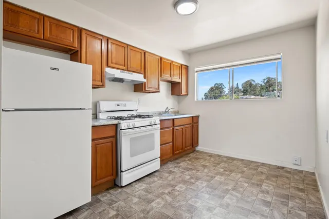 a kitchen with stainless steel appliances a refrigerator sink and cabinets