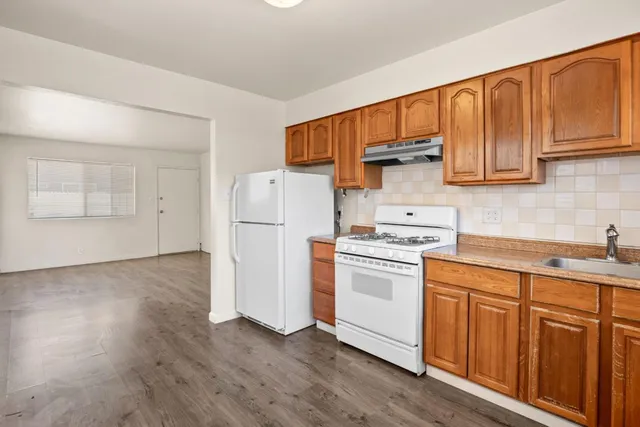 a kitchen with a white cabinets and white appliances