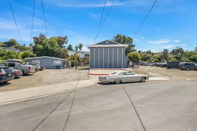 a view of a patio with a table and chairs under an umbrella