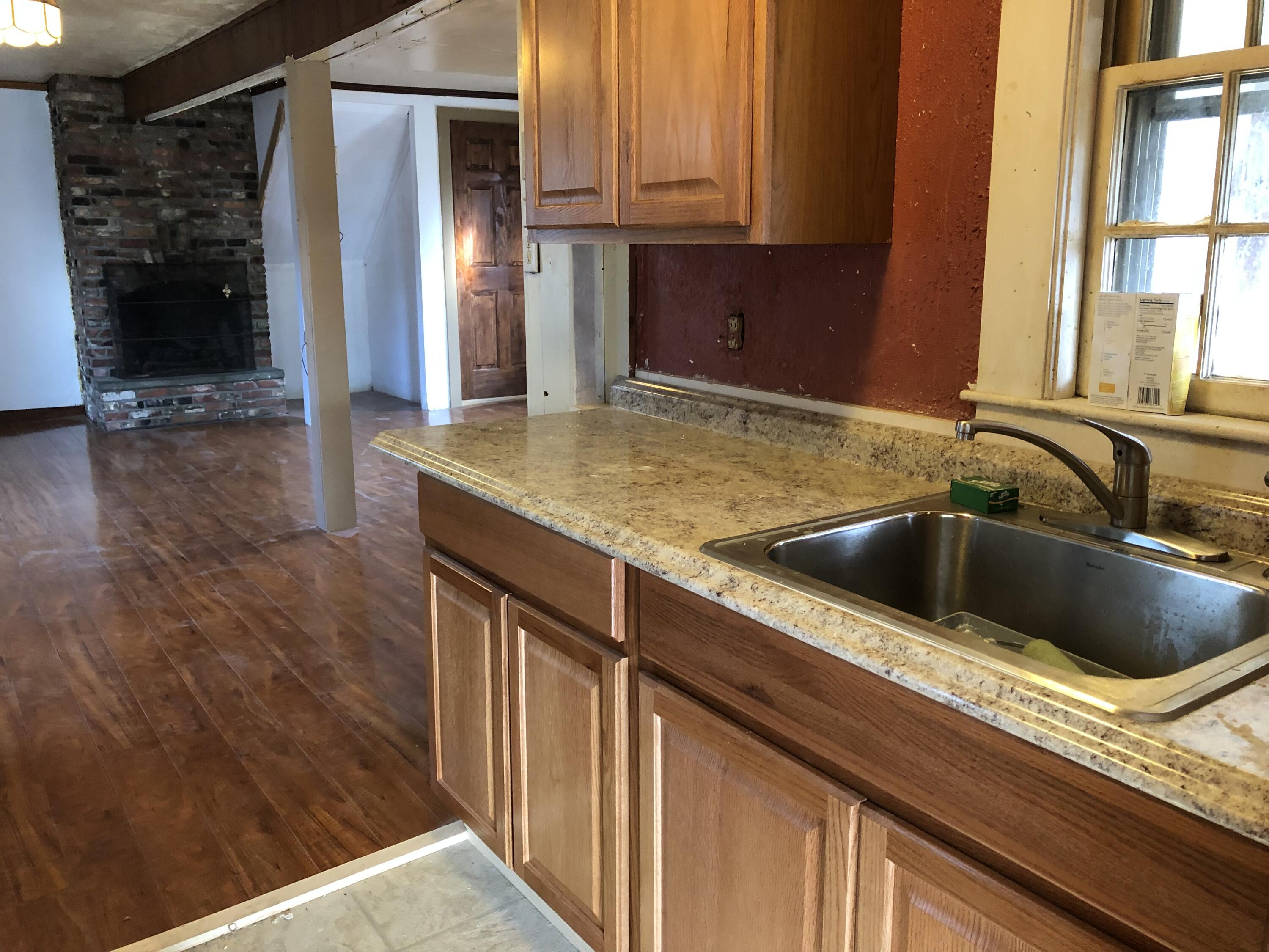 347 Santuit-Newtown Road Marstons Mills, MA 02648 - Photo 11 of 26 a kitchen with a sink and a refrigerator