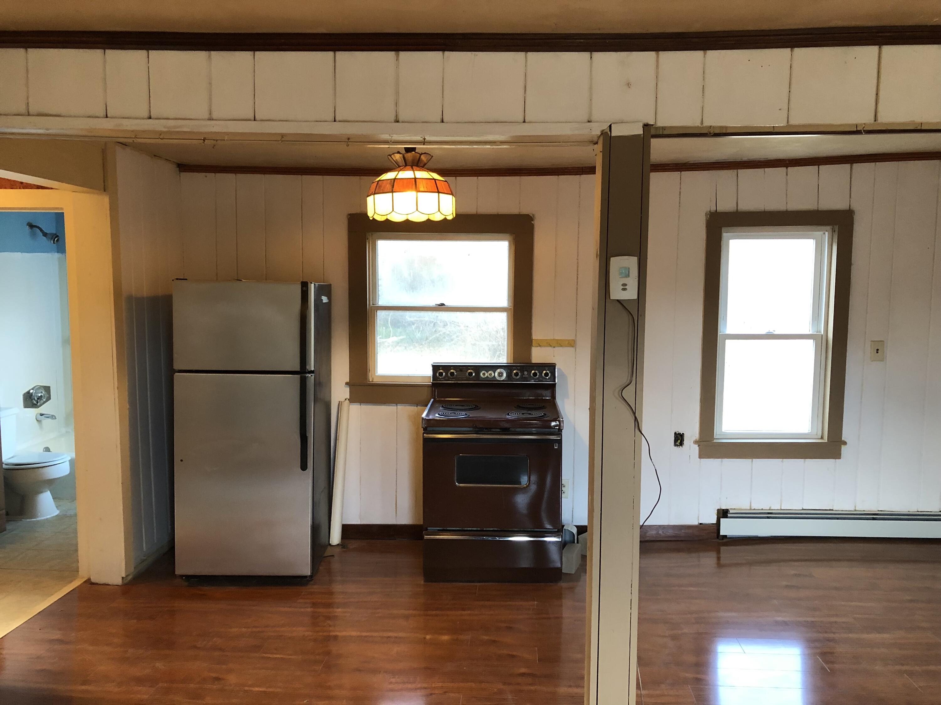 347 Santuit-Newtown Road Marstons Mills, MA 02648 - Photo 13 of 26 a kitchen with a refrigerator and a stove