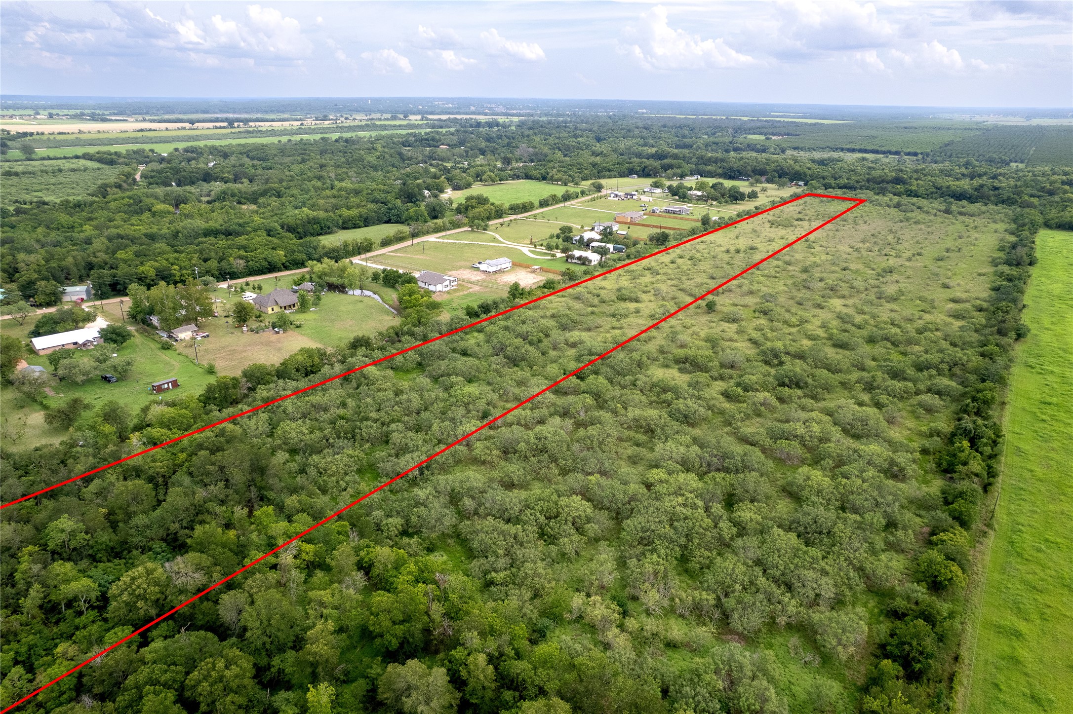 969 Rd Elgin Tx 78602 Road Elgin, TX 78621 - Photo 6 of 17 Aerial overview of property's location with property parcel outlined and a forest