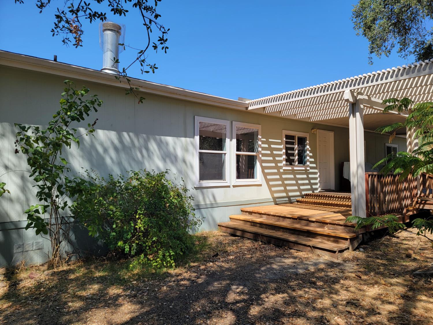 37041 Dunlap Road Squaw Valley, CA 93675 - Photo 2 of 24 a backyard of a house with wooden deck table and chairs