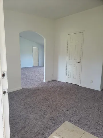 a view of an empty room and closet area