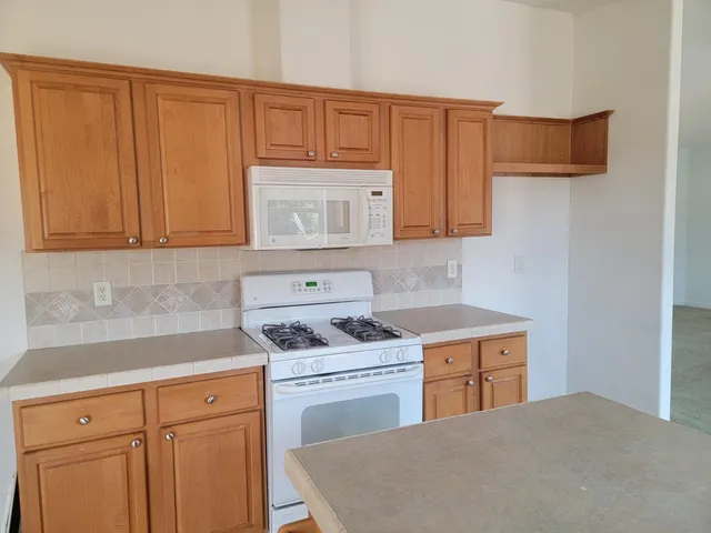 a kitchen with cabinets and appliances