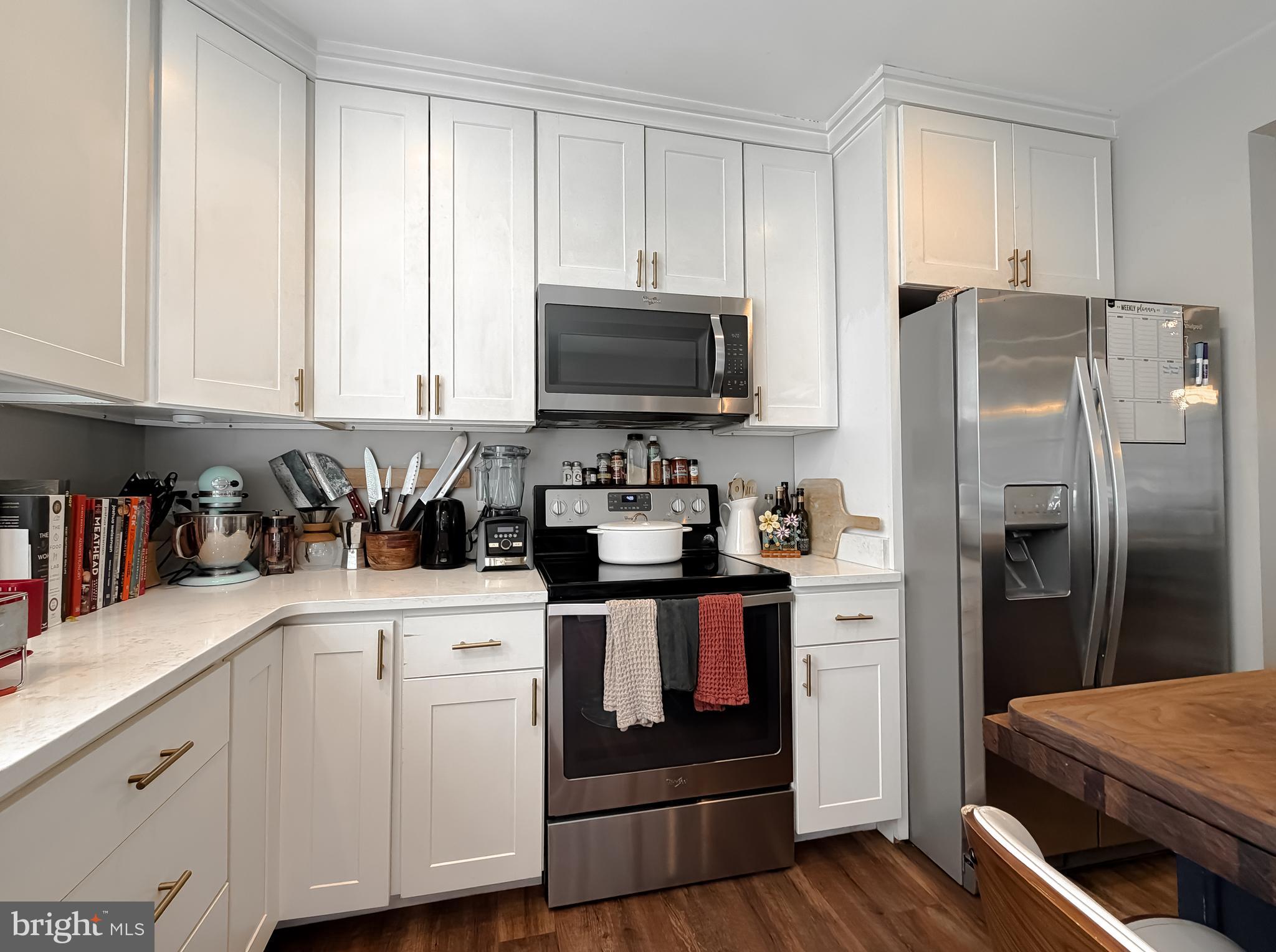 16146 Thomas Road Piney Point, MD 20674 - Photo 7 of 57 a kitchen with stainless steel appliances granite countertop a stove a sink and a refrigerator