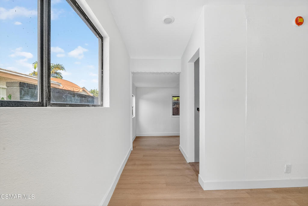 2251 Bryce Road El Monte, CA 91732 - Photo 11 of 16 a view of a hallway with wooden floor and a large window