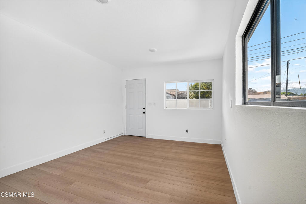2251 Bryce Road El Monte, CA 91732 - Photo 12 of 16 an empty room with wooden floor and windows