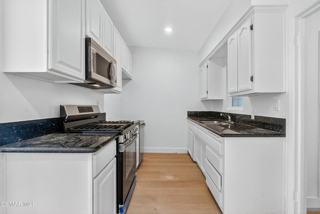 2251 Bryce Road El Monte, CA 91732 - Photo 4 of 16 a kitchen with stainless steel appliances granite countertop a stove and a microwave
