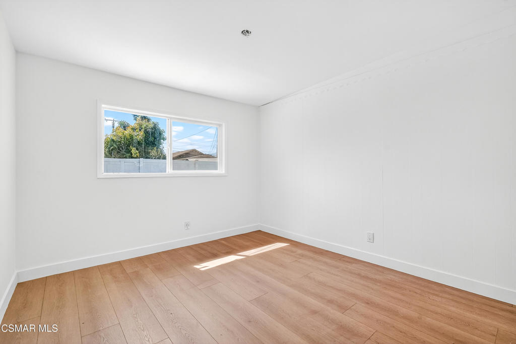 2251 Bryce Road El Monte, CA 91732 - Photo 7 of 16 an empty room with wooden floor and window