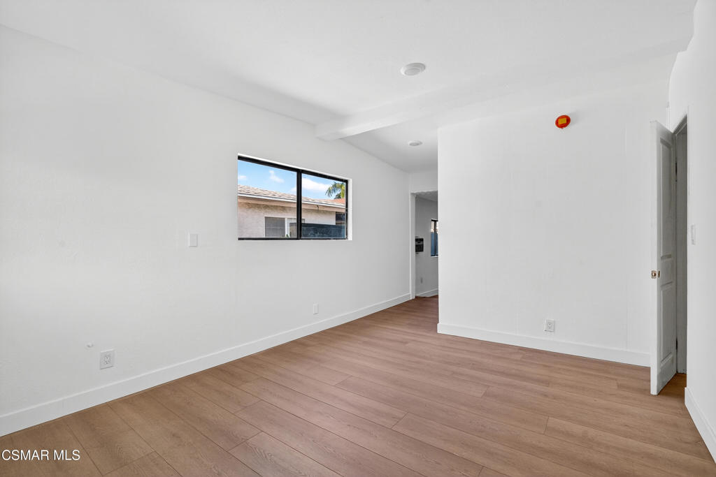 2251 Bryce Road El Monte, CA 91732 - Photo 10 of 16 an empty room with wooden floor and windows