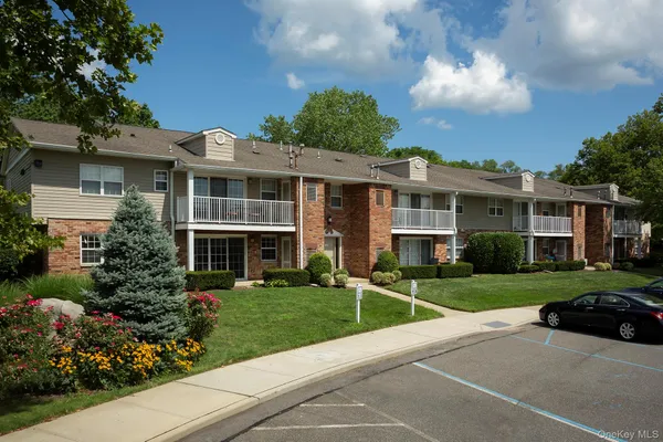 a front view of a house with a yard and outdoor seating