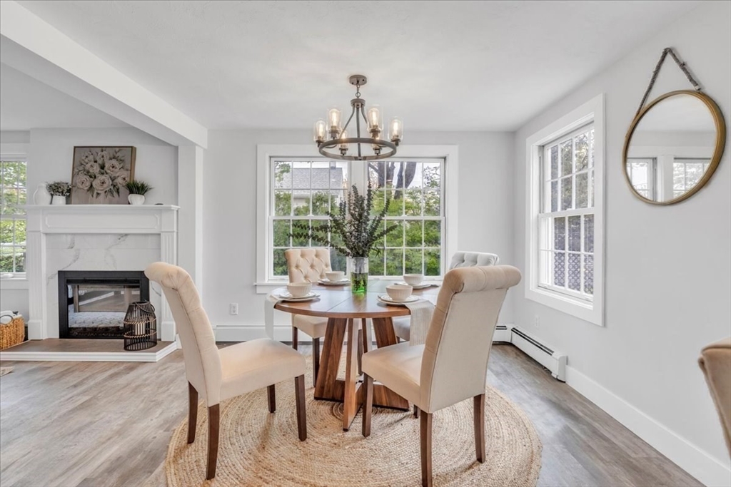 6 Everett Avenue Wareham, MA 02571 - Photo 5 of 33 a dining room with furniture a fireplace and a chandelier