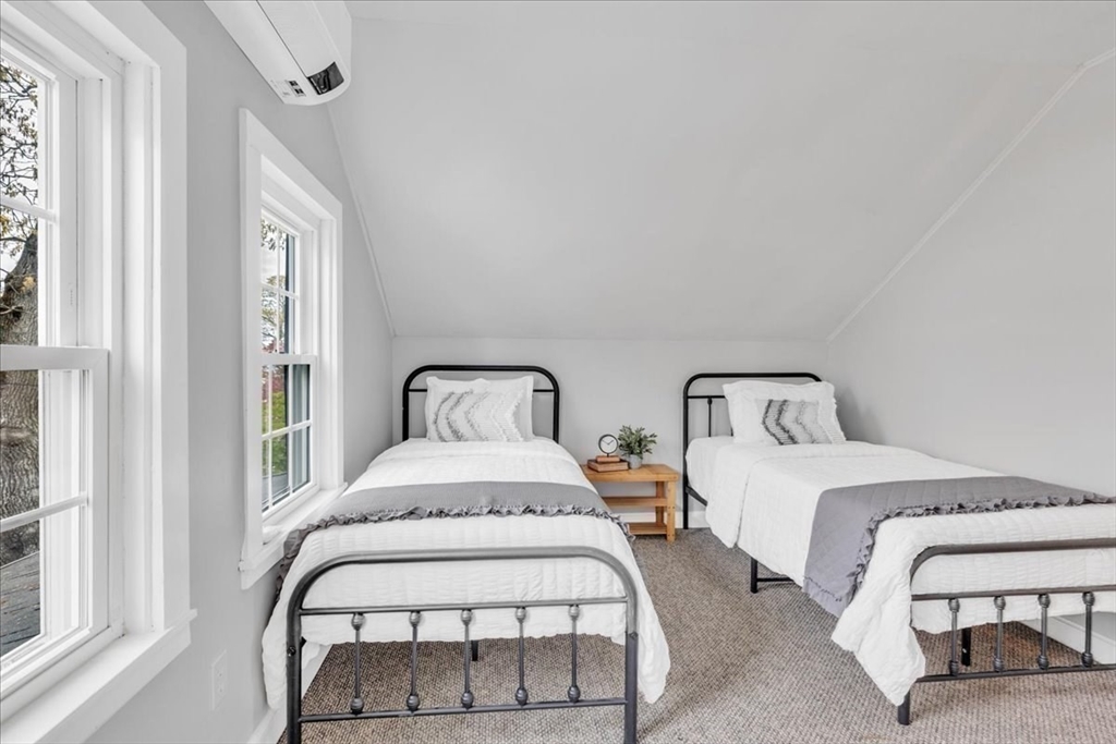 6 Everett Avenue Wareham, MA 02571 - Photo 10 of 33 a bedroom with two beds and a large mirror next to a window