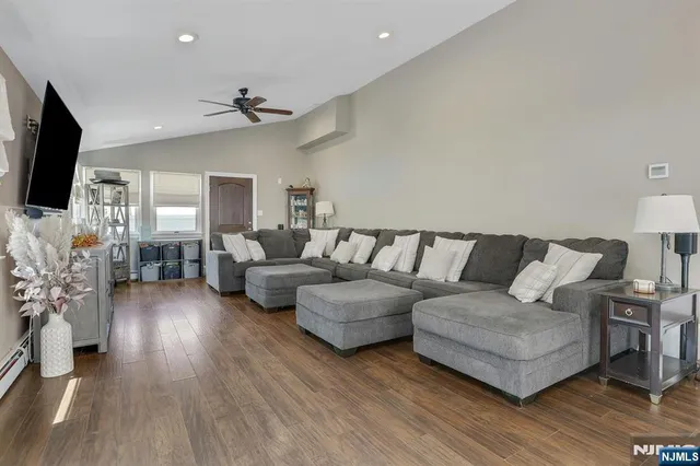 a kitchen with stainless steel appliances kitchen island granite countertop a table chairs sink and cabinets