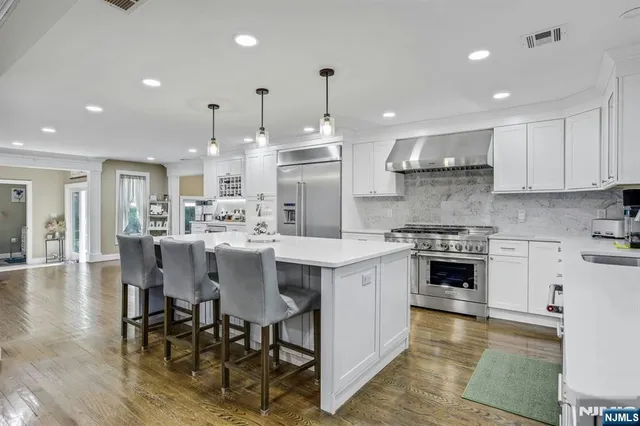 a kitchen with granite countertop a stove and a sink