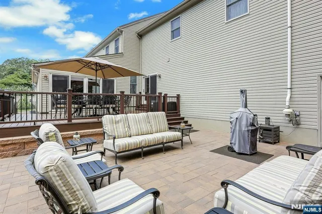 a view of a house with a big yard and sitting area
