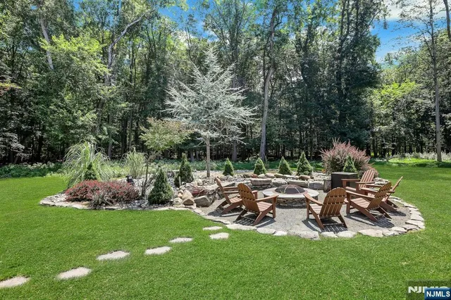 a view of a house with a yard and sitting area