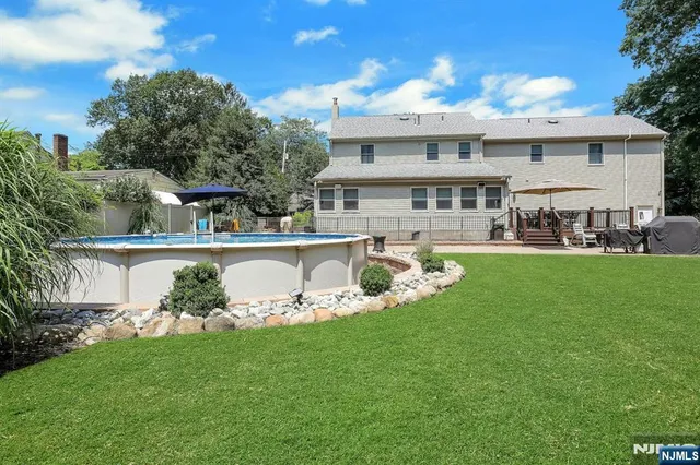 a view of a patio with table and chairs and wooden floor