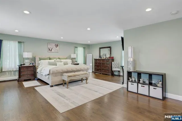 a bathroom with a granite countertop sink a mirror and shower