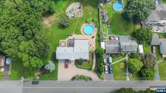an aerial view of a house with outdoor space and swimming pool